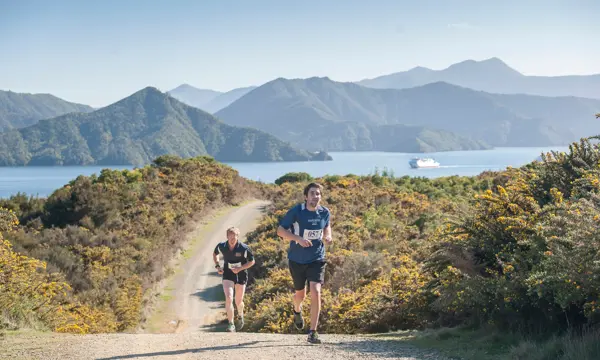 Two runners jog up a gravel road during the picturesque Marine 2 Marina competition